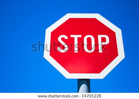 Stop sign in contrast with blue sky...
