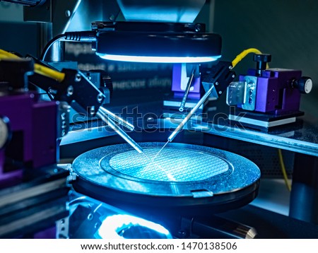 Close-up study of the test sample of the transistor microchip under a microscope in the laboratory. Equipment for testing chips. Production automation. Manufacture of chips. Royalty-Free Stock Photo #1470138506