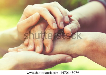 two women generations, family relationship, senior people care, close up young female hands holding wrinkled hand of senior woman, blurred green nature background   Royalty-Free Stock Photo #1470145079