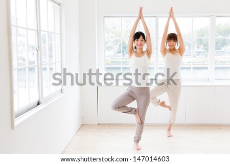 attractive asian women exercising in the room