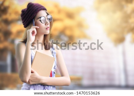 Close up university student woman thinking and holding pen hand near the face in the garden.