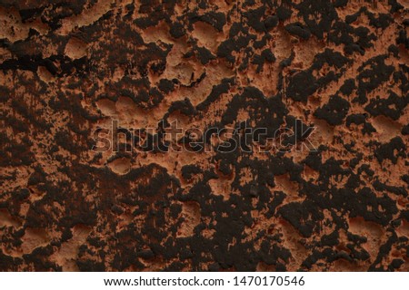 Grunge background texture very embossed wall surface texture painted in black and light orange, macro photo.