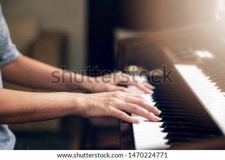 backgound of close up of hands playing piano