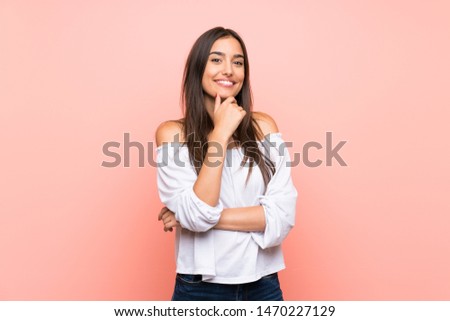 Young woman over isolated pink background smiling