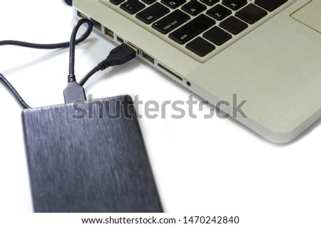 External hard drive connect to laptop computer on the white background.