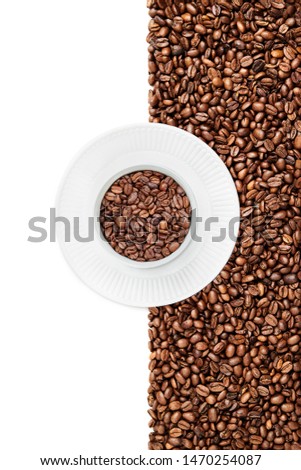 Round Mug of coffee beans on the white plate suraunded by roasted coffee beans and a white background, negative space left part of the image