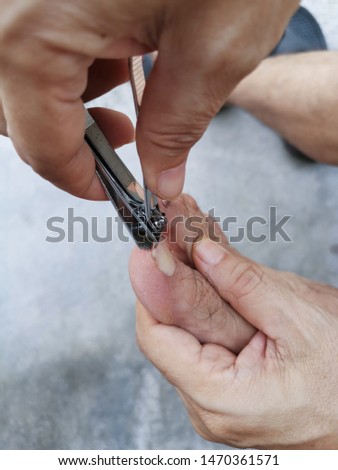 close up scene of person cutting hand or toe nails. 