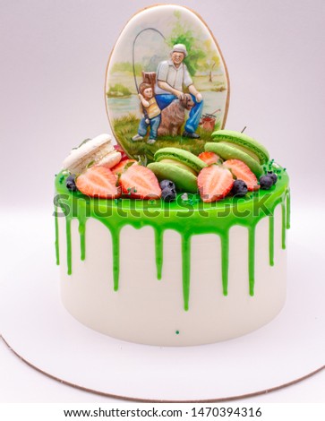 Cake decorated with green chocolate drops, berries, macaroons and gingerbread.