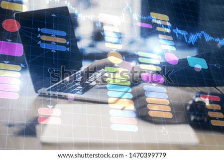 Close up of hands using laptop and writing at workplace with abstract programming interface. Artificial intelligence and information concept. Double exposure 