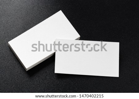 Mockup of business cards at dark background.