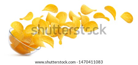 Potato chips falling into glass bowl isolated on white background with clipping path, flying potato crisps Royalty-Free Stock Photo #1470411083
