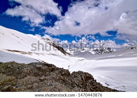 Burzil Pass is a high mountain pass at located in the Himalaya Range, near Gilgit. It is a lush green valley with a stream flowing across its length. Tall mountains, with snow and flora