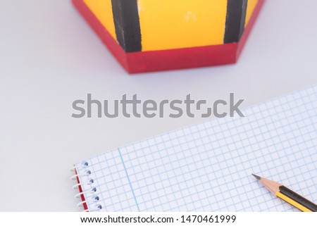 new school supplies, a grid notebook next to a pencil