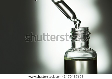 Cosmetic or medical glass bottle with pipette. Skin care concept. Natural hard light, deep shadows. - Image Royalty-Free Stock Photo #1470487628
