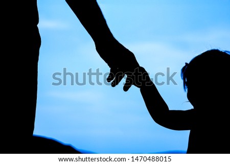 happy parent with child in nature by the sea silhouette