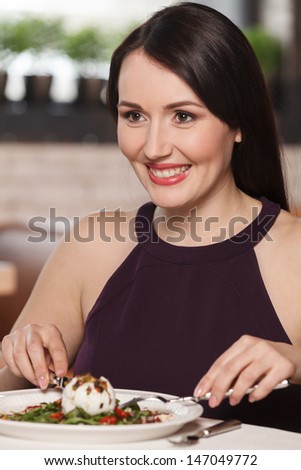 Women at restaurant. Portrait of beautiful middle-aged women eating at the restaurant