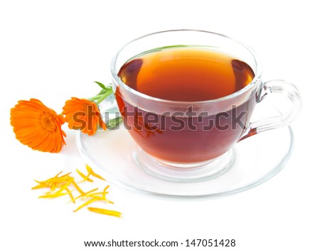 Tea cup with calendula flowers on a white background
