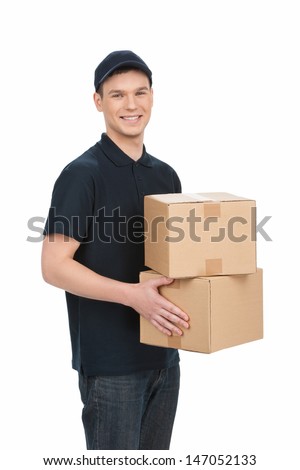 Deliveryman at work. Cheerful young deliveryman holding a box stack and smiling at camera