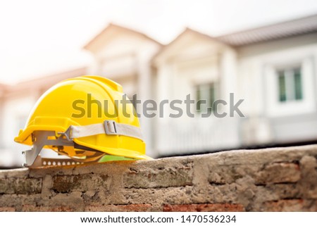 Yellow helmet on house background 