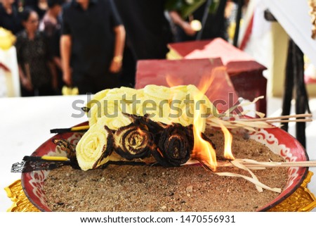 fire burn sandalwood flower on sand in plate
