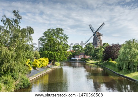 Three-floor Smock Mill in Hinte, Lower Saxon Mill Road, East Frisia, Germany  Royalty-Free Stock Photo #1470568508