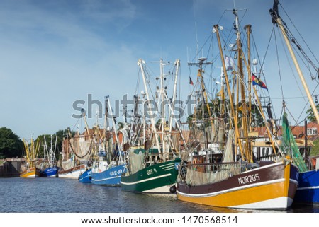 Fishing Ships in the harbor of Greetsiel, Germany Royalty-Free Stock Photo #1470568514
