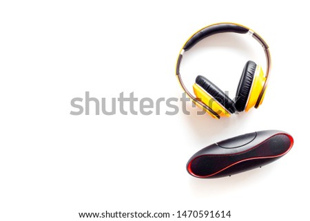 Wireless headphones and portable speaker on white background top view copyspace