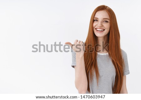 You better see it. Charming lively happy smiling redhead girl blue eyes pointing thumb left giving direction showing cool place hang out asking out friend drink coffee order take-away laughing