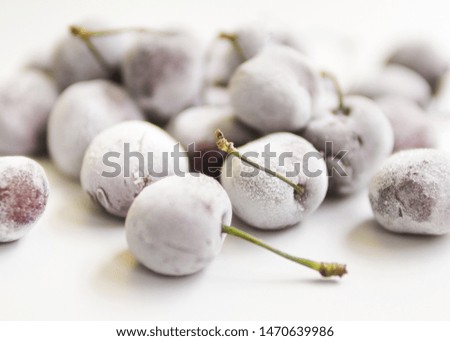 Sweet dark and pulpy berries covered with hoarfrost