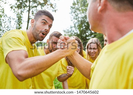 Astonished man arm wrestling in a competition at the teambuilding event
