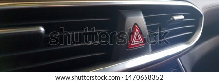 Modern closeup of black emergency stop button car on dark background. Future technology concept. Industrial safety. Automotive technology warning sign.