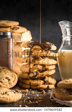 Pattern image of The different Creamy Dark Chocolate cookies tower rich of butter poured with dark chocolate syrup set on the abstract color sheet table background ; made freshly