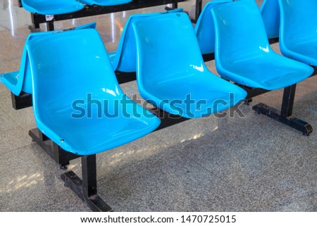 Blue plastic chair row for customers, public place facility. New bench for public office customers. Reception chairs closeup. Waiting in public office concept photo. Airport facility asset