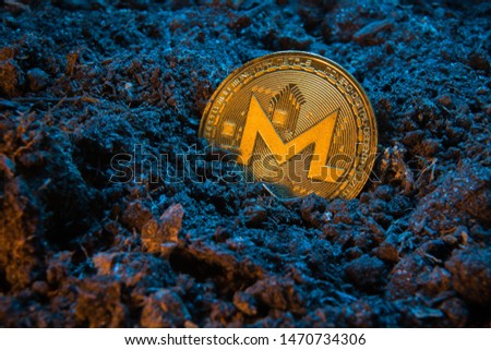 Mining crypto currency - Monerd. Online money coin in the dirt ground. Digital currency, block chain market, online business