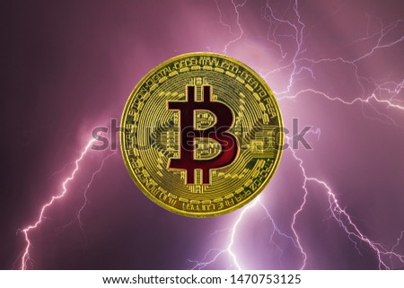 Bitcoin and cryptocurrency investing concept - Bitcoin coin against the sky with lightning.