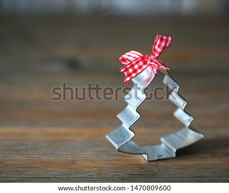 Wooden background with Christmas tree cookie cutter