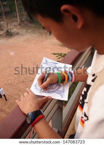 a boy making freehand sketch drawing 