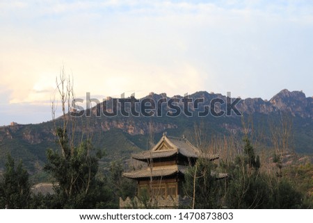 The Simatai Great Wall with some old Chinese houses in Beijing, China. The picture is taken in evening.