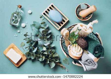 Wooden soap dish, soap, eucalyptus over green background. Zero waste, natural organic bathroom tools. Plastic free life. Ecological skin care, body treatment concept. Royalty-Free Stock Photo #1470882224