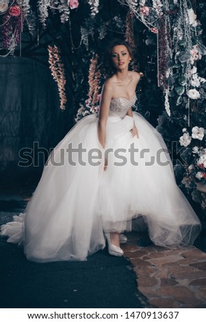 Bride in the park is a beautiful long wedding dress. Luxurious woman in a wedding dress in Paris on the Elysian fields. Happy bride