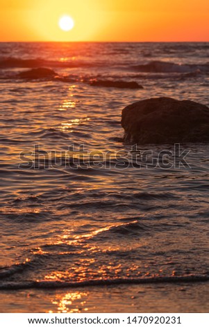 Orange Sunset over the Sea, light reflection on the waves In Israel Netanya beach Royalty-Free Stock Photo #1470920231