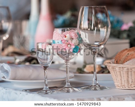 Two glasses of champagne on the background of the wedding bouquet of roses.