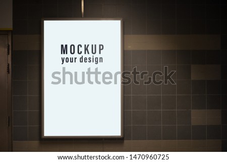 Mock up of light box in a city on the wall for your advertising. Blank mock up of vertical street poster billboard for your text message or promotional content. street advertising billboard mockup.