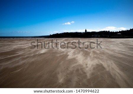 St Andrews west sands on a windy day.  The St Andrews skyline can be seen in the background.