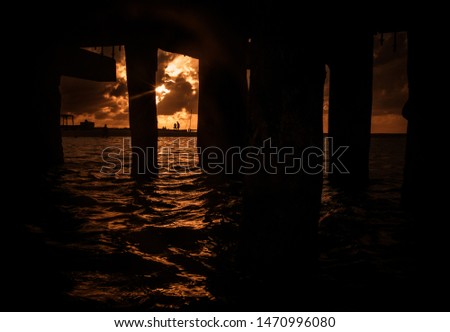 Sunset seen from under the pier