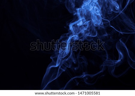 Movement of smoke on black background, blue smoke background, picture on wallpaper, design concept
