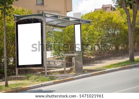 advertising board at bus stop on asphalt road