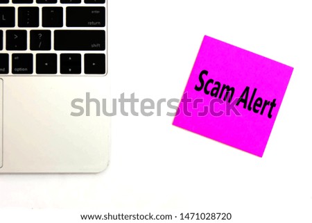 Post it with Scam Alert on keyboard background. 
Sticker note paper Scam Alert on laptop for copy space. Internet fraud hacking scams concept. 
top view.