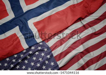 waving colorful flag of united states of america and national flag of norway.