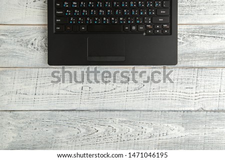 laptop on vintage shabby white wooden background. the view from the top. flat lay